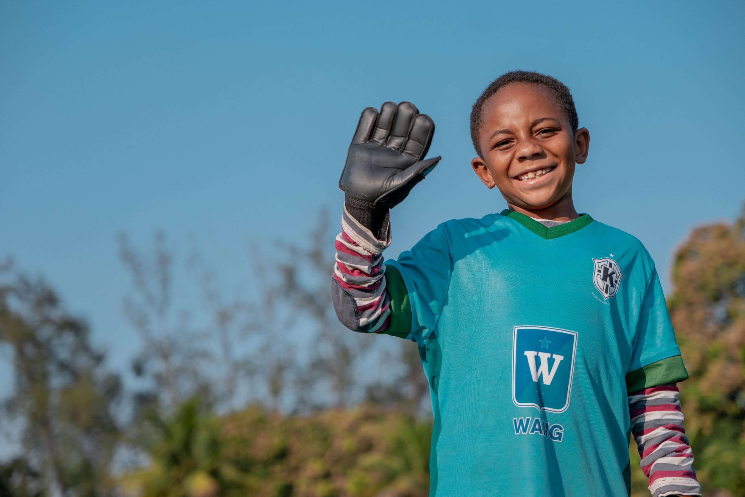 a young football player waving