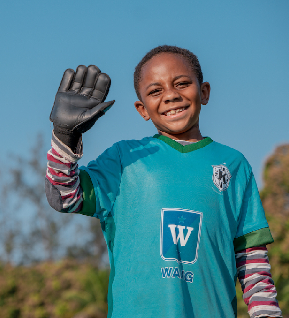 a young football player waving